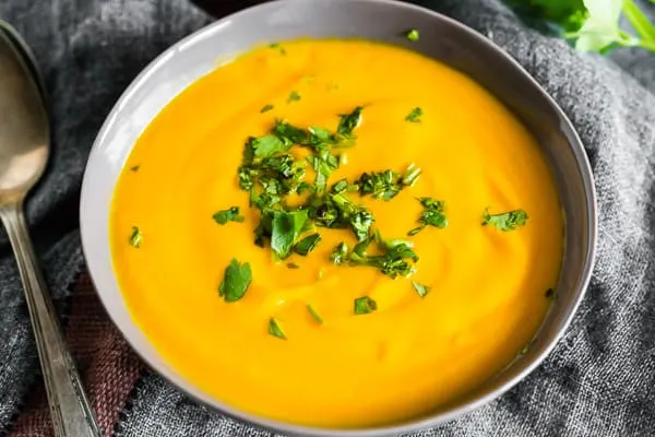 Creamy Carrot Orange Soup topped with minced cilantro. 