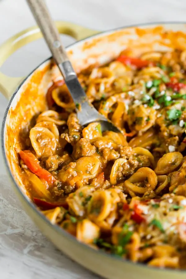 one pot ground chicken fajita pasta with a spoon in a yellow dish