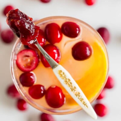 This cranberry gin fizz is a great addition to your holiday cocktail rotation. Made with gin, fresh squeezed orange juice, homemade whole berry cranberry sauce and a splash of fizzy water. You'll love this simple winter cocktail. 