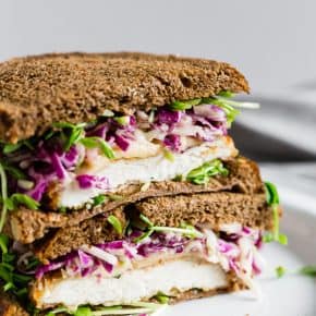 This crispy chicken sandwich with cabbage apple slaw takes the flavors of fall and puts them into a sandwich. It’s a perfectly cooked crispy chicken cutlet topped with smoked Gouda cheese, pea shoots, and a homemade tangy red cabbage apple slaw. You’ll love this killer sandwich.