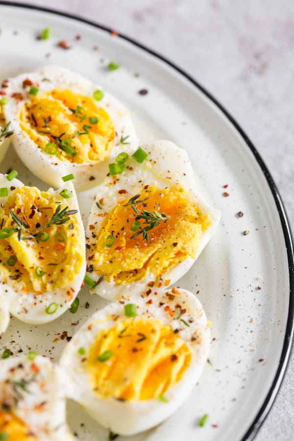 Instant Pot Hard Boiled Eggs topped with fresh herbs and spices. 