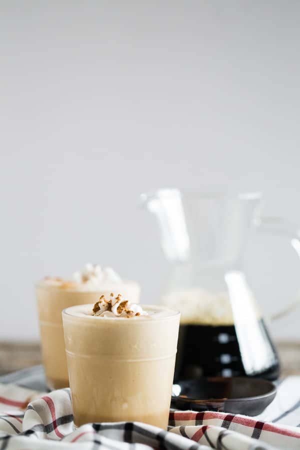 Pumpkin Spice Coffee Protein Shake in a glass with whipped cream. 