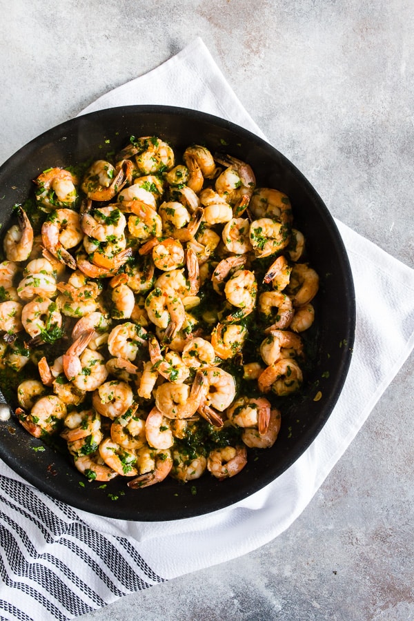This spicy garlic cilantro shrimp is the perfect easy dinner or party appetizer. Made with spicy cayenne olive oil, dry sherry, lots of thinly sliced garlic, garlic chili sauce, wild-caught shrimp and lots of fresh cilantro. You’ll love this quick and easy dish!