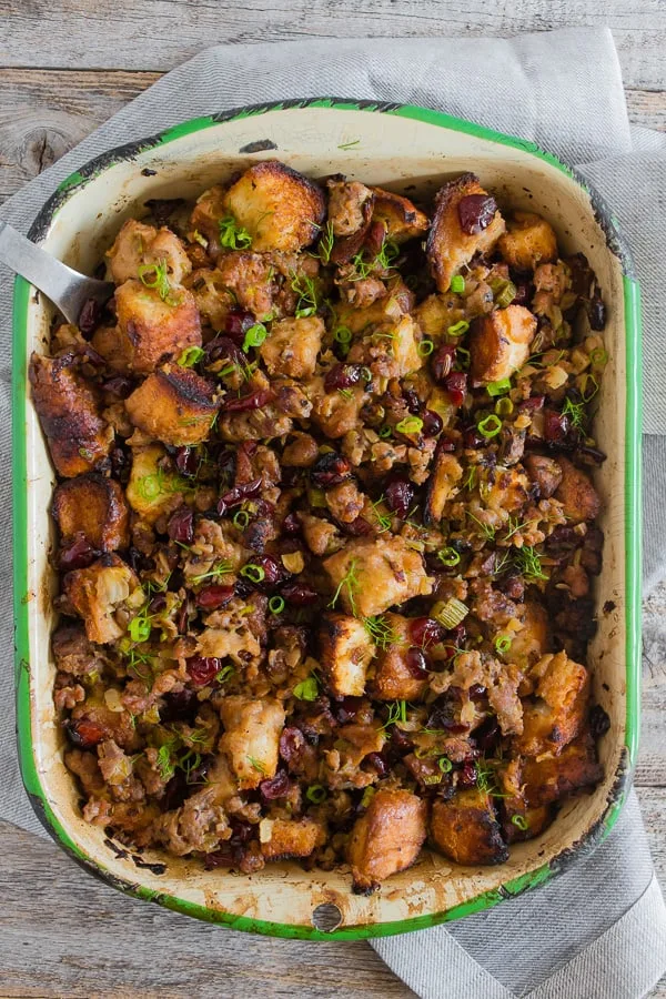 This Texas toast stuffing is full of garlic bread Texas toast, spicy and sweet turkey Italian sausage, fennel, green onions, and dried cranberries. It's a fun twist to traditional stuffing that is packed full of flavor and super simple to make.