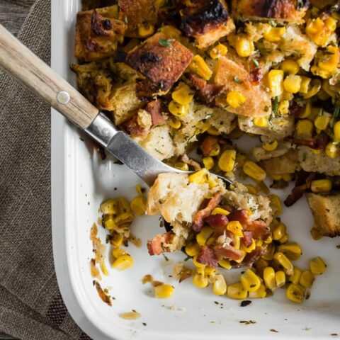 This Bacon Corn Sourdough Stuffing is a great twist on the classic holiday stuffing. It’s packed full of crispy sourdough bread chunks, sweet corn, salty bacon, caramelized onions, and tons of fresh herbs and garlic. You’re going to love this easy and delicious stuffing recipe!