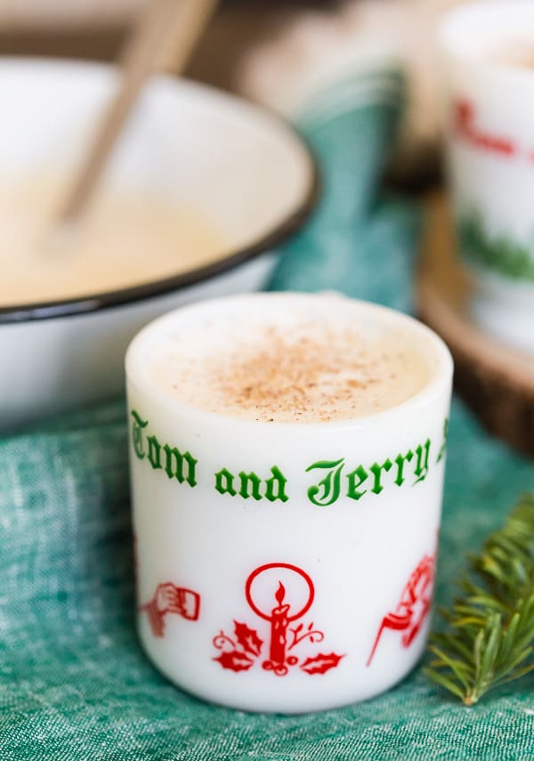 This Tom and Jerry cocktail recipe is the perfect boozy treat to keep you happy all holiday season long! You start with a delicious batter mixed with hot water or milk and just a splash (or two!) of spiced rum. This vintage cocktail is about to make a big comeback!