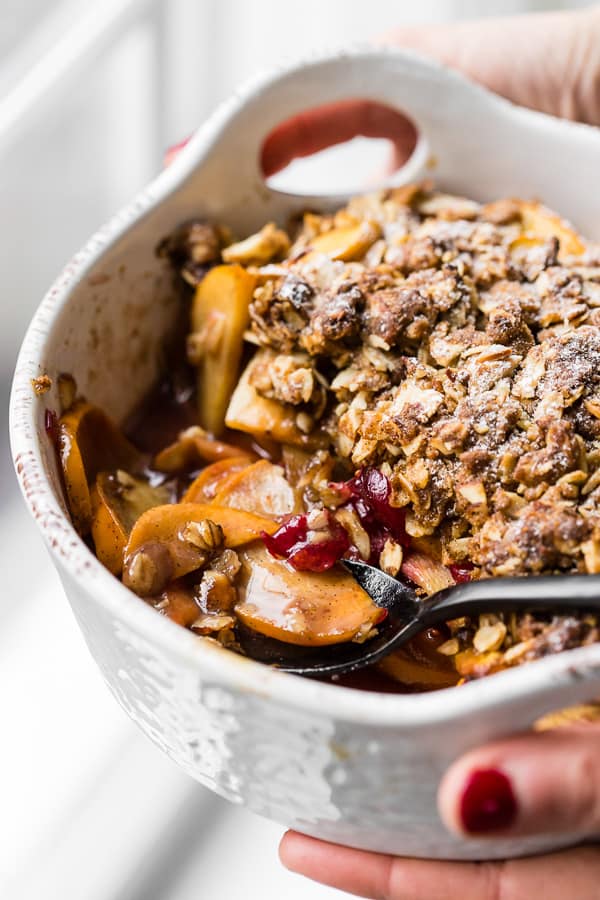 This vanilla persimmon crisp is the perfect holiday dessert. It's made with thinly sliced seasonal persimmons, chopped fresh cranberries, vanilla bean paste and topped with a homemade vanilla oat and almond mixture. You'll love this simple winter dessert!