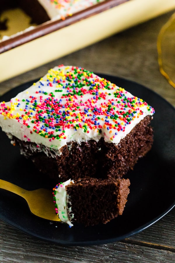 fluffy cream cheese frosting with a fork cutting into the cake