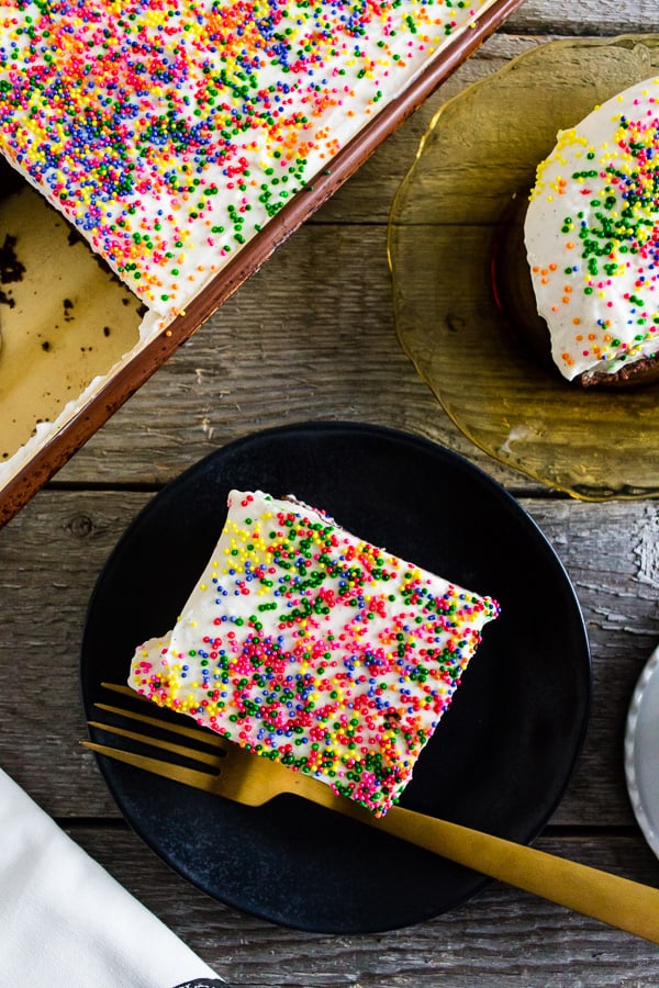 fluffy cream cheese frosting on top of chocolate cake with sprinkles