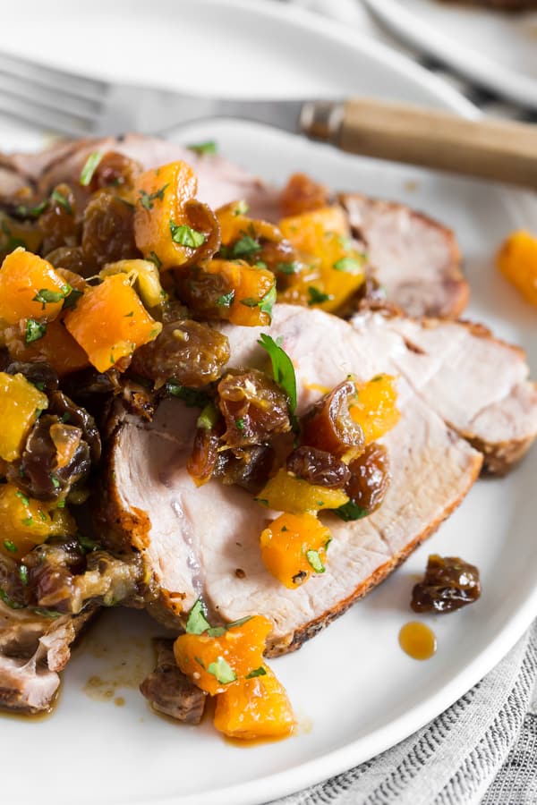 This roast pork loin with dried fruit compote is an easy and flavorful dinner recipe that your whole family will love. Serve with rice, buttered noodles or even mashed potatoes. Juicy roast pork served with a homemade compote made out of golden raisins, dried apricots, dates, orange juice and just a touch of cilantro. So good!