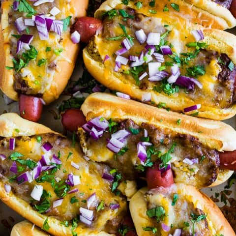 These oven baked chili cheese dogs are the perfect party meal! Made right on a sheet pan and then oven baked until hot and melty.