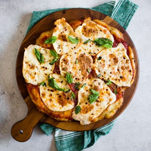 This smoked mozzarella pizza is topped with a light layer of marinara sauce, freshly smoked mozzarella cheese, fresh herbs and a sprinkle of grated Parmesan. It's packed full of flavor and cooks in just about 20 minutes. 