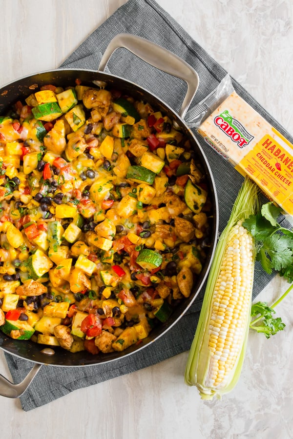 This Tex Mex chicken and vegetable skillet is ready in just 30 minutes and a great way to use up all of those summer vegetables. It's packed full of zucchini, yellow squash, sweet summer corn, bell peppers, seasoned chicken and topped with the just the right amount of spicy Cabot habanero cheddar cheese. Serve alone or piled high on rice. Either way, it's totally delicious!