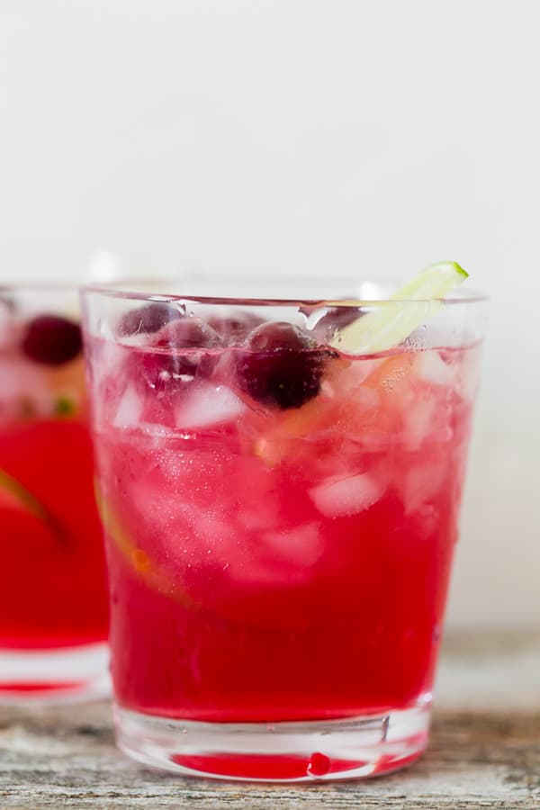super close up of cranberry lemonade ginger beer cocktail with white background