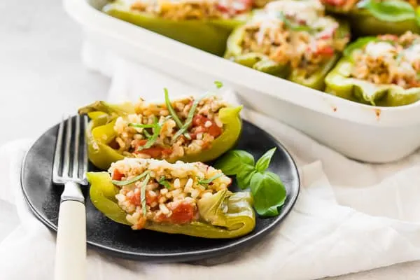 sliced in half ground chicken stuffed bell peppers
