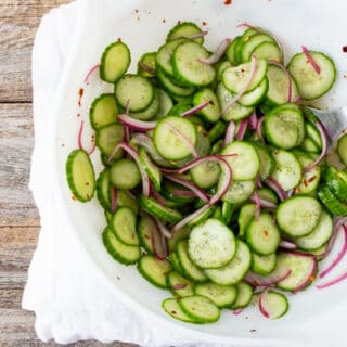 large white bowl filled with sliced cucumber salad