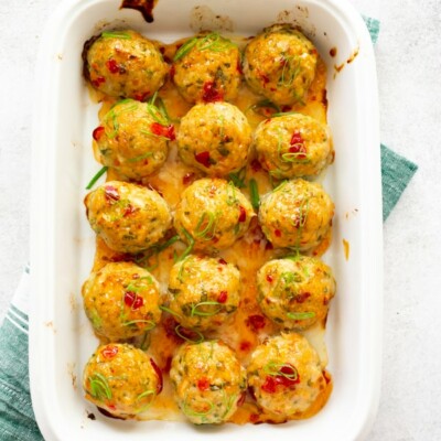 easy thai baked chicken meatballs in a white dish with a green napkin