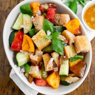 grilled sourdough panzanella salad with tomatoes in a bowl