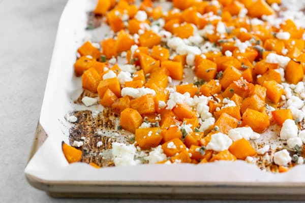 honey roasted butternut squash on a sheet pan with parchment paper