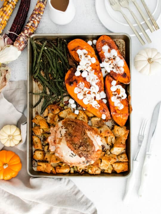 sheet pan thanksgiving dinner on a sheet pan surrounded by fall decor