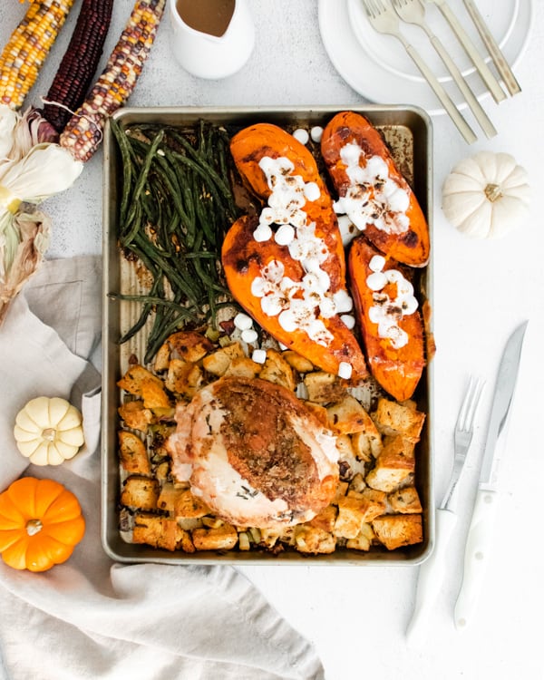 sheet pan thanksgiving dinner on a sheet pan surrounded by fall decor