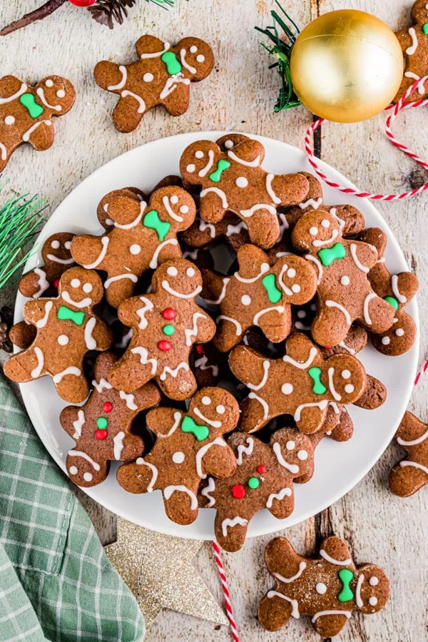 Soft gingerbread cutout cookies on a white plate with green napkin