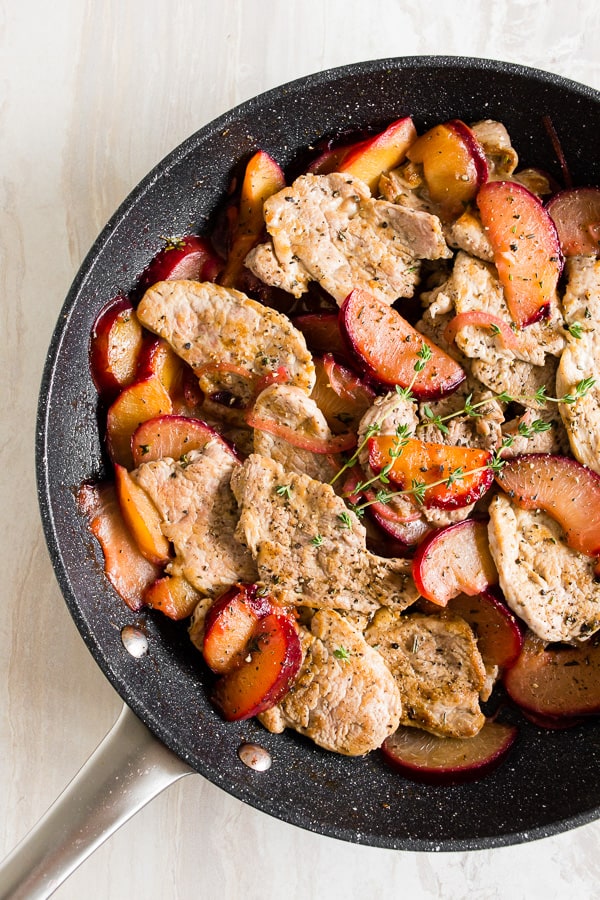 skillet pork tendrloin with plums in a skillet shot from overhead