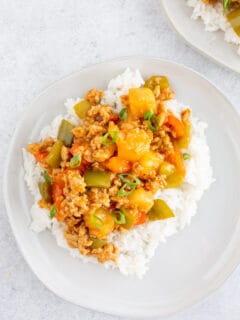 sweet and sour ground chicken on a plate with rice