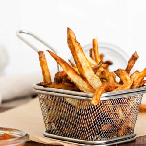Garlic Parmesan Air Fryer French Fries in a metal basket