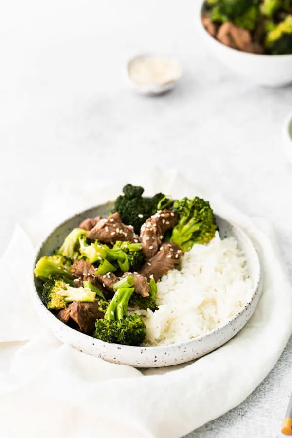 Air Fryer Beef and Broccoli served with white rice and sesame seeds. 