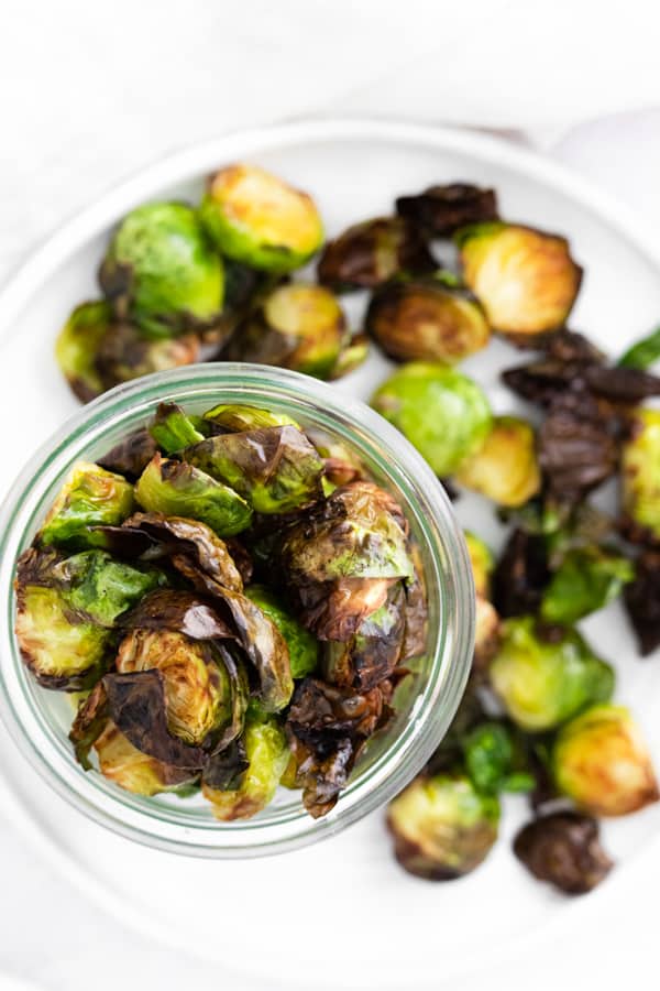 Air Fryer Brussels Sprouts served in a bowl and on a plate. 