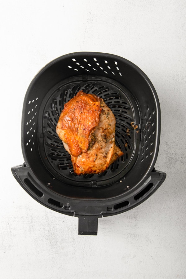 Air fried turkey breast in an air fryer basket. 