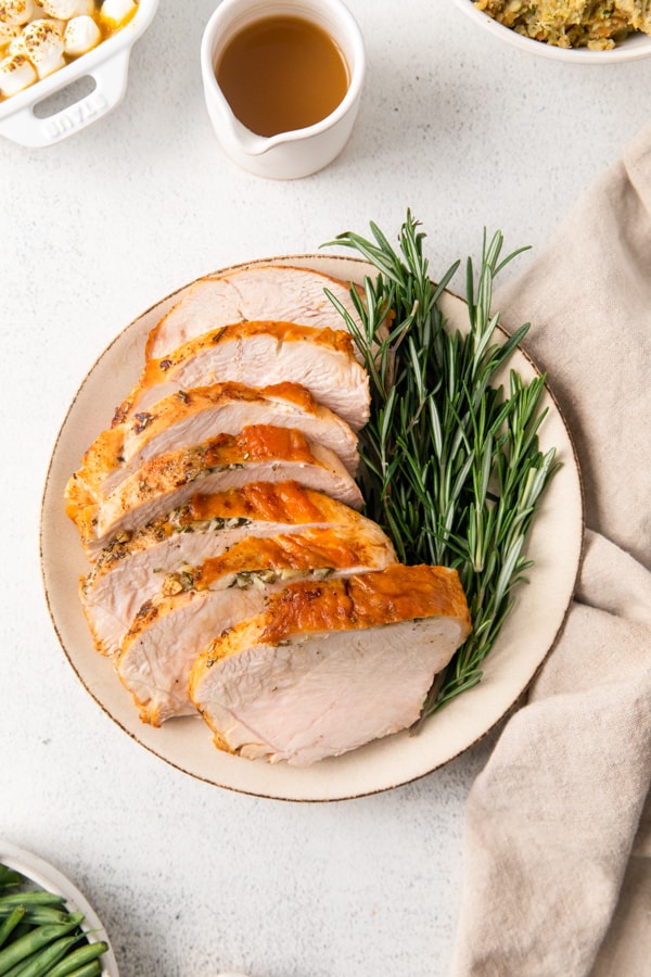 Air Fryer Turkey Breast sliced on a white serving plate. 