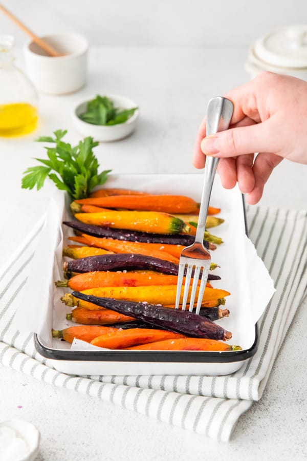 a fork picking up a Honey Roasted Carrot.