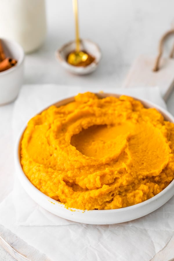 Instant Pot Mashed Sweet Potatoes in a white serving bowl. 