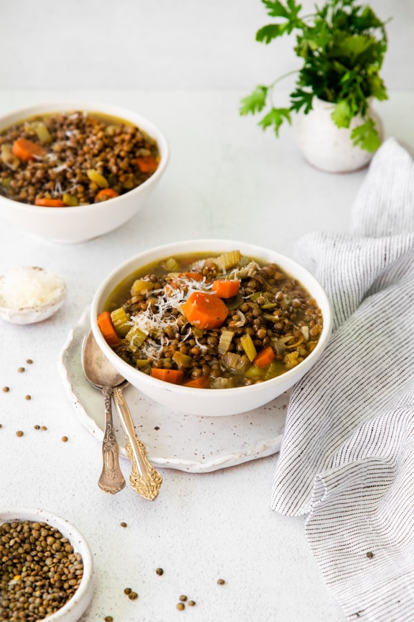 Healthy French Lentil Soup in a bowl with a spoon on the side. 