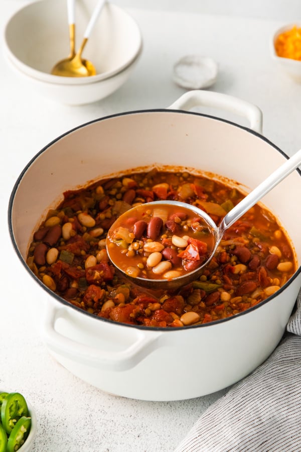 A dutch oven with Vegan Lentil Chili in it. 