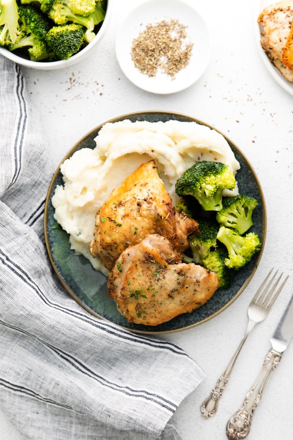 Air Fryer Chicken Thighs served with potatoes and broccoli. 