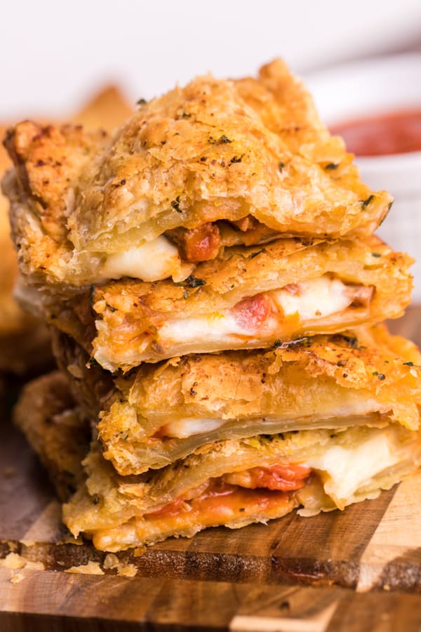 Air Fryer Pizza Hot Pockets sliced on a cutting board. 