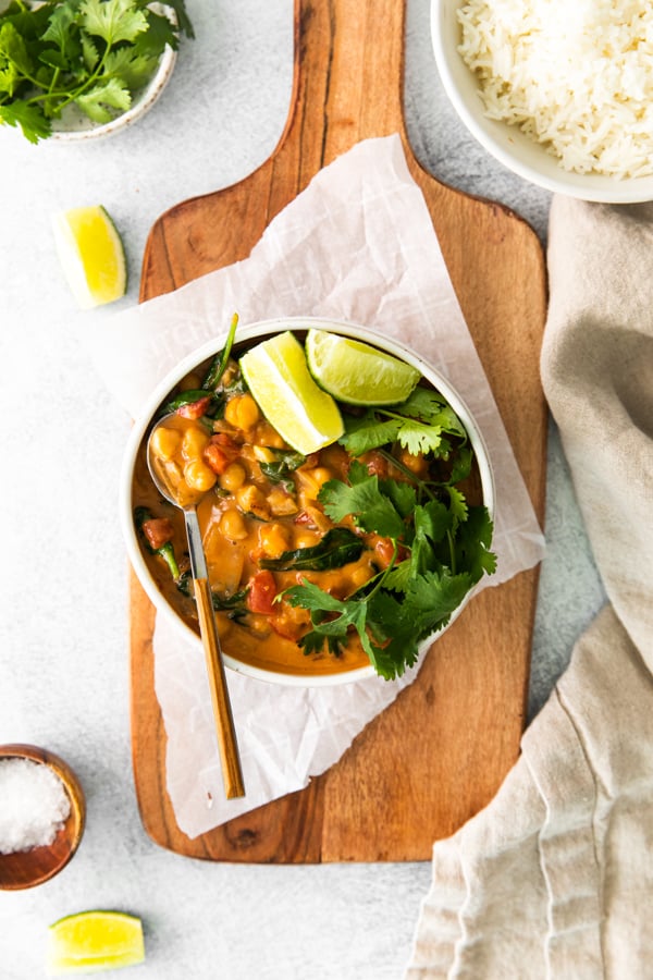 Vegan Chickpea Curry served in a bowl with cilantro and lime. 