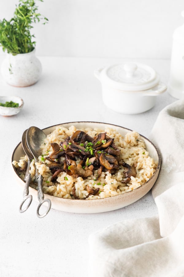 Wild Mushroom Risotto in a serving bowl with serving spoon. 