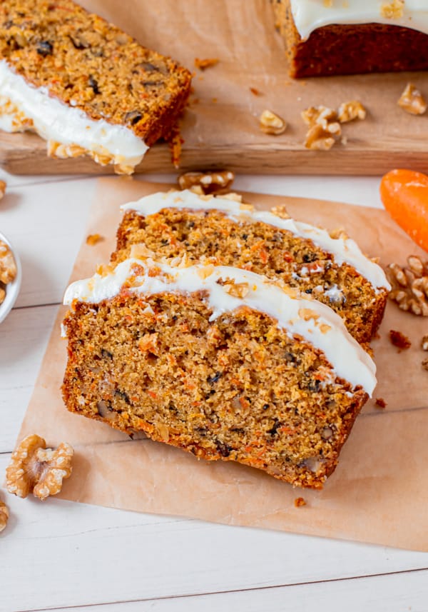 Carrot Cake Loaf Cake sliced on parchment paper. 