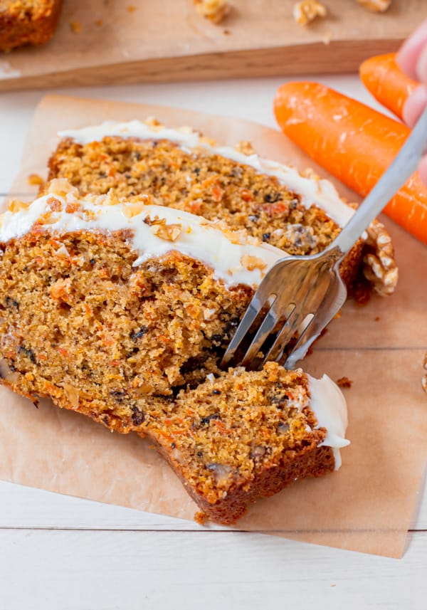 A fork taking a bite of Carrot Cake Loaf Cake. 