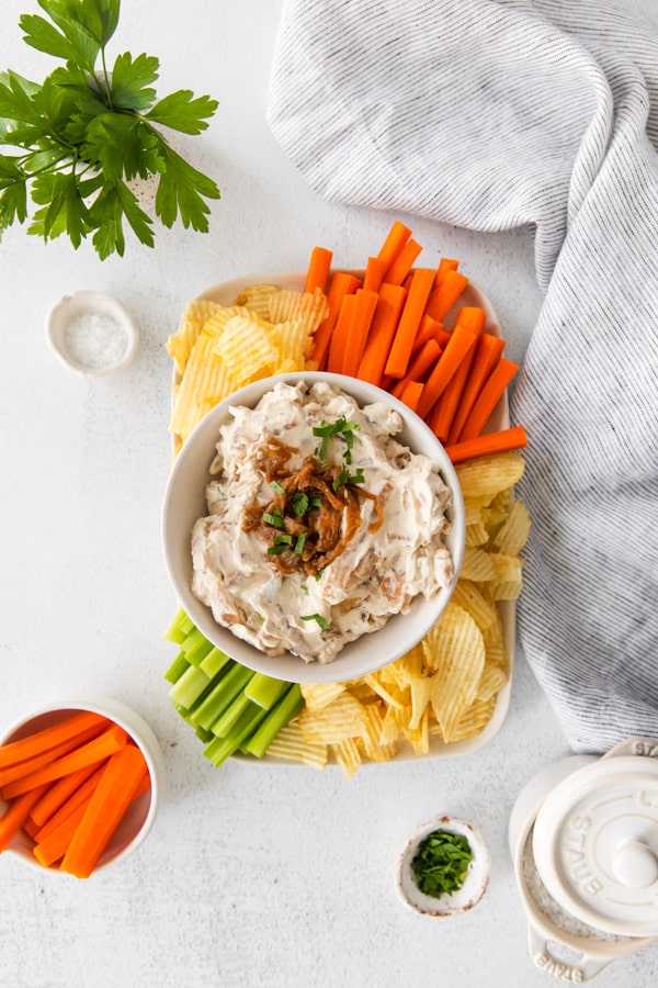 French Onion Dip served with carrots, celery, and chips.