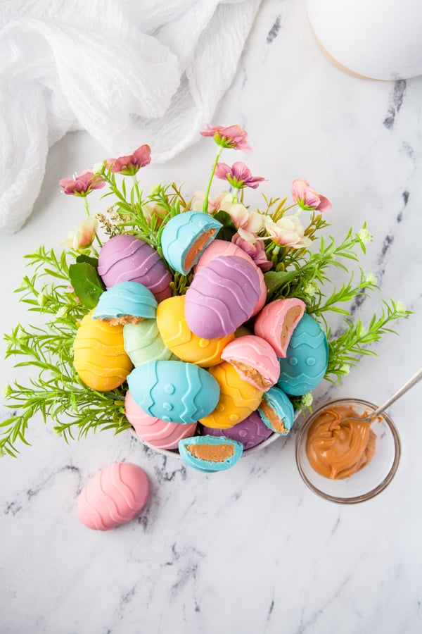 Peanut Butter Eggs served in a bowl with flowers. 