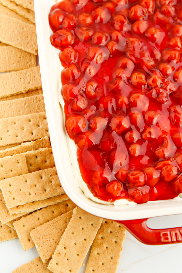 Cherry Cheesecake Dip served in a dish with graham crackers. 