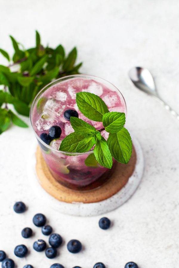 Blueberry Mojito garnished with blueberries and mint. 