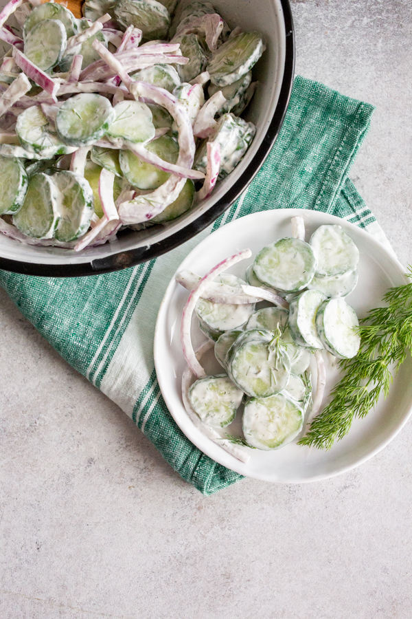 Creamy Cucumber Salad on a white plate. 