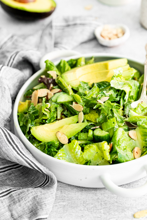 Green Goddess Salad topped with avocado and almonds. 