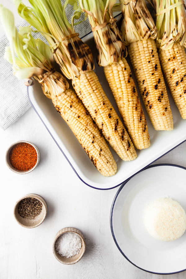 Ingredients to make Grilled Mexican Corn on a sheet pan. 